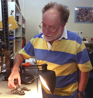Randy Korotev, research associate professor of earth and planetary science, examines fragments of the Sikhote-Alin iron meteorite that fell in Siberia in 1947. The sample is the real McCoy, but Korotev regularly receives samples from meteorite enthusiasts that are wrong McKongs. Mistakenly identifed meteorites have the quaint moniker of meteorwrongs.