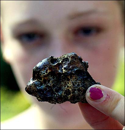 Siobhan Cowton shows off a piece of rock, thought to be a meteorite, which fell from the sky and landed on her foot /PA